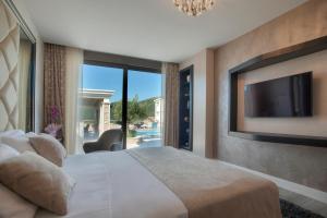 a bedroom with a large bed and a tv at Villa Salute in Budva +125 photos