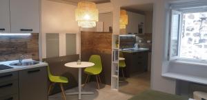 a kitchen with a table and chairs and a sink at Apartments Giron in Dubrovnik