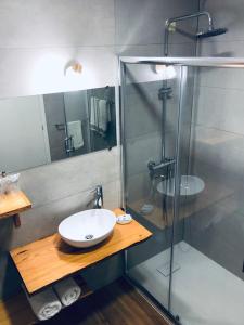 a bathroom with a sink and a shower at Hotel Termas in Chaves