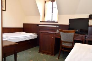 Postel nebo postele na pokoji v ubytování Hotel Buchlovice