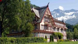 a large building with a mountain in the background at Irenegarden - Panorama apartment in Lauvstad
