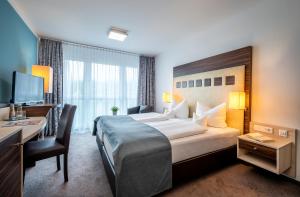 Postel nebo postele na pokoji v ubytování AVALON Hotel Bad Reichenhall