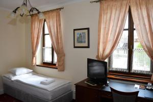 Postel nebo postele na pokoji v ubytování Hotel Buchlovice