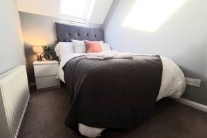 a bedroom with a large bed with a blue headboard at Cosy up in Palmers Leaze in Bristol
