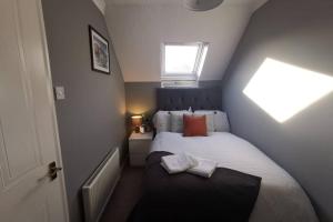 a small bedroom with a bed and a window at Cosy up in Palmers Leaze in Bristol