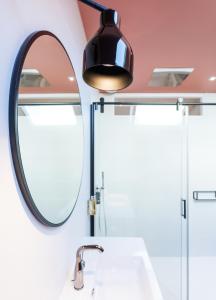 a bathroom with a sink and a mirror at Les Apparts de Marin in Laval