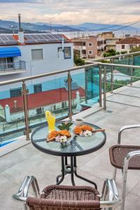 a table with food on top of a balcony at Rent House Diamond in Iraklitsa