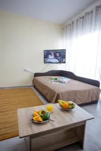 a room with a bed and a table with fruit on it at Rent House Diamond in Iraklitsa