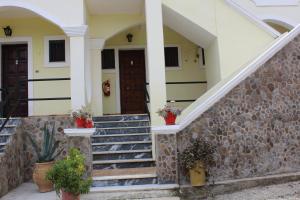 una casa con scale e un muro di pietra di Marina 1990 ad Agios Georgios Pagon