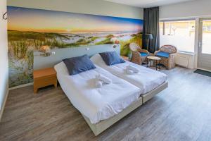 Posteľ alebo postele v izbe v ubytovaní `t Wapen van Terschelling