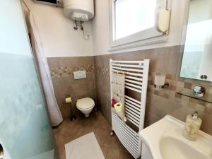 a small bathroom with a toilet and a sink at Apartments Villa Bazilika in Sečovlje +57 photos