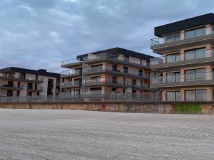 a building with balconies on the side of a street at Apartament IDEAL in Dziwnów