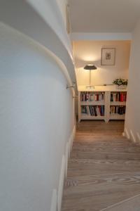 een hal met een witte muur en een boekenplank bij Watthüs in Morsum