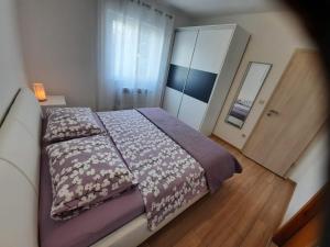 a bedroom with a large bed and a closet at Villa Antonio in Jelsa