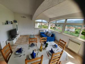 a living room with a table and a blue couch at Villa Antonio in Jelsa