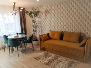 a living room with a couch and a table at Apartment For You in Šiauliai