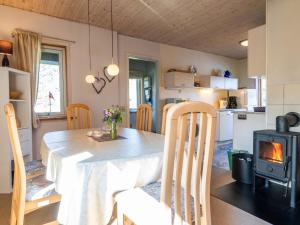 a kitchen and dining room with a table and a stove at 5 person holiday home in Nørre Nebel in Nørre Nebel