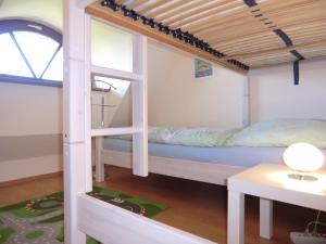 a bunk bed in a room with a window at Hollandwarft in Pellworm