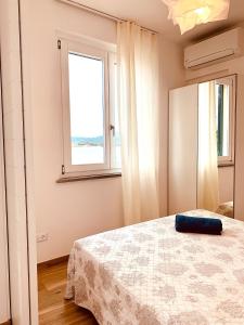 a bedroom with a bed and a window at La Casa di Mia in Marina di Campo