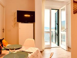 a dining room with a table and a view of a balcony at La Casa di Mia in Marina di Campo