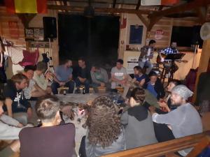 een groep mensen die rond een tafel in een kamer zitten bij Rafting Tara Camp Highlander in Bastasi