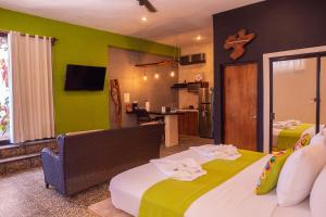 a hotel room with two beds and a kitchen at Bahia Tolok in Isla Mujeres