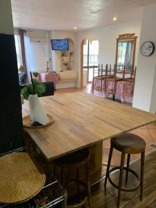 a large wooden table in a living room at F2 Tapu in Papeete