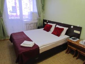 A bed or beds in a room at Yakutia Hotel
