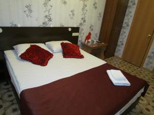 A bed or beds in a room at Yakutia Hotel