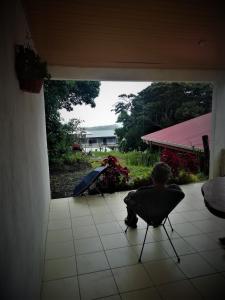 Ein Junge auf einem Stuhl auf einer Terrasse in der Unterkunft Villa Morella in Monteverde Costa Rica