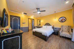 a hotel room with a bed and a chair at Athenia Hoi An Boutique Hotel & Spa in Hoi An