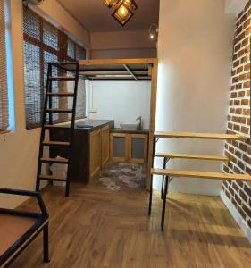 a room with a loft bed and a kitchen at Tiny Home in Miri