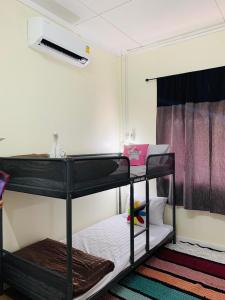 Postel nebo postele na pokoji v ubytování Baan Mae Somkid Homestay