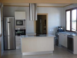 a kitchen with stainless steel appliances and a counter top at Huerto del Medico in Reig