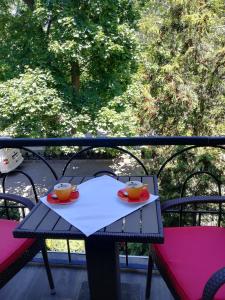 a table with two cups on top of a balcony at Hotel RENO on Deribasovskaya in Odesa