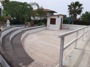 a concrete patio with a railing next to a house at agriturismo heaven in Capo Vaticano