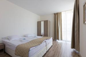 a bedroom with a bed and a large window at Zevs Residence in Nesebar +102 photos