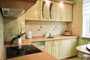 a kitchen with white cabinets and a sink at Mieszkanie Nad Morzem in Ustka +16 photos