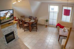 ein Wohnzimmer mit einem Esstisch und einem TV in der Unterkunft Ferienwohnung Ostseefeeling 3 in Ostseebad Karlshagen