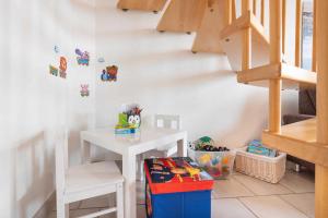 a childs room with a white table and stairs at Ferienwohnung Ostseefeeling 4 in Ostseebad Karlshagen