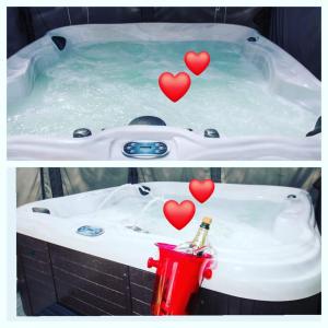 a bath tub with hearts in the water and a red fire hydrant at Studio London & Studio Chalet in Pannes
