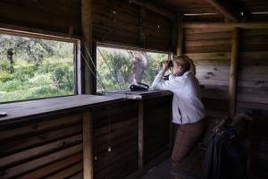 a woman talking on a cell phone in a cabin at Palacio Viejo de Las Corchuelas in Torrejón el Rubio
