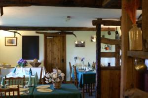 a dining room with tables with green table cloth at Middle Flass Lodge in Bolton by Bowland