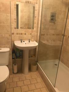 a bathroom with a sink and a shower at The Fairways in Portsmouth