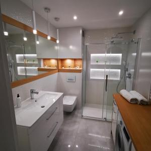 Un baño con ducha, lavabo e inodoro. en Apartament IDEAL, en Dziwnów 41 fotos más