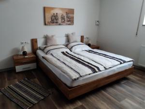 a bedroom with a large bed with wooden floors at Fewo Judith in Balesfeld