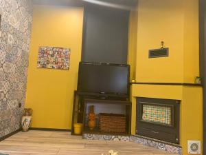 a living room with a tv and a fireplace at Trakia Street Apartment in Plovdiv