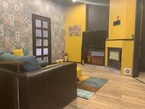 a living room with a couch and a television at Trakia Street Apartment in Plovdiv +25 photos
