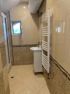 a bathroom with a sink and a shower at Trakia Street Apartment in Plovdiv