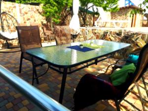 a table and chairs sitting on a patio at Guest House Barkhat in Zatoka